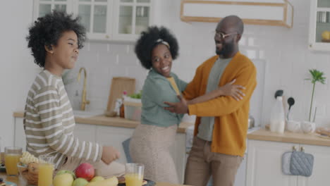 happy family dancing in the kitchen