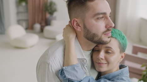 Close-Up-Of-A-Loving-Young-Couple-Hugging-And-Tenderly-Looking-At-Each-Other-At-Home