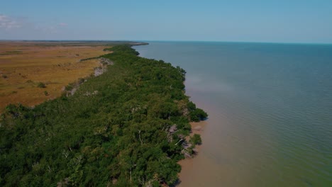 Aerial-over-mangroves,-ocean-and-a-swamp-in-Holbox,-Mexico