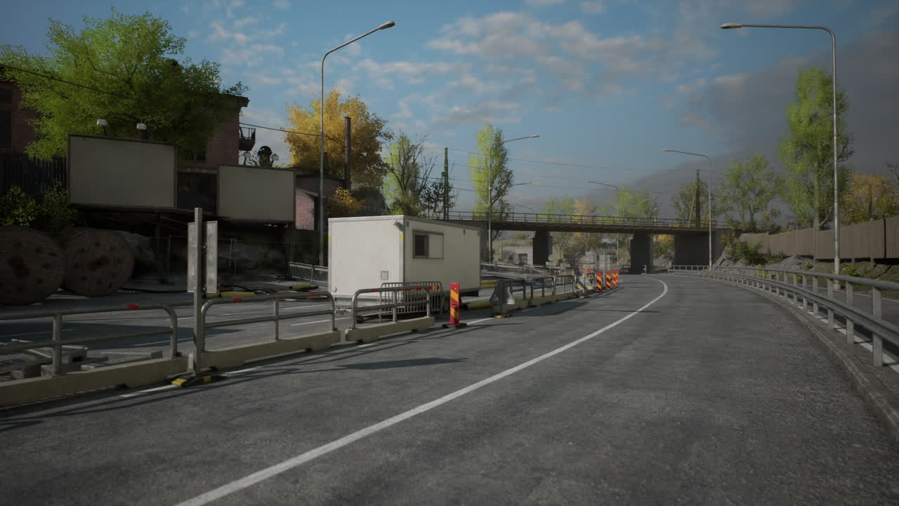 Road under construction with workers and equipment near a bridge