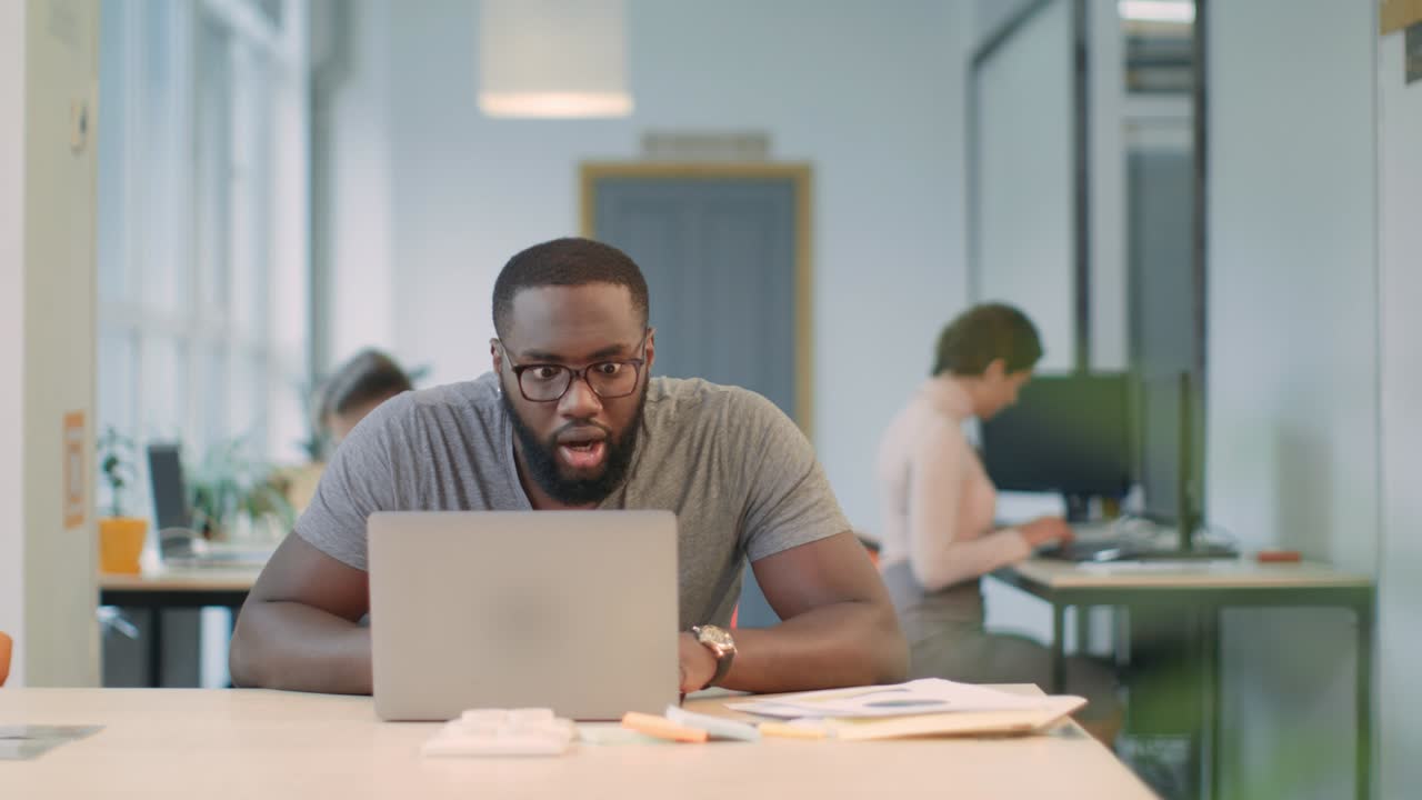 African business man feeling happy of work results. Exited man get good results