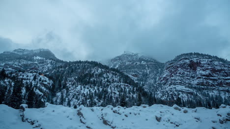 time lapse of dark winter day in mountains, snow capped hills and valley outside ouray, colorado usa