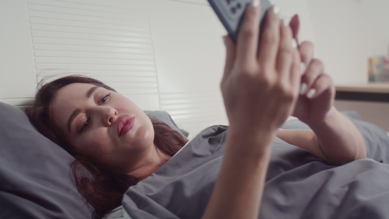Woman Waking up Hearing Alarm Ringing on Phone