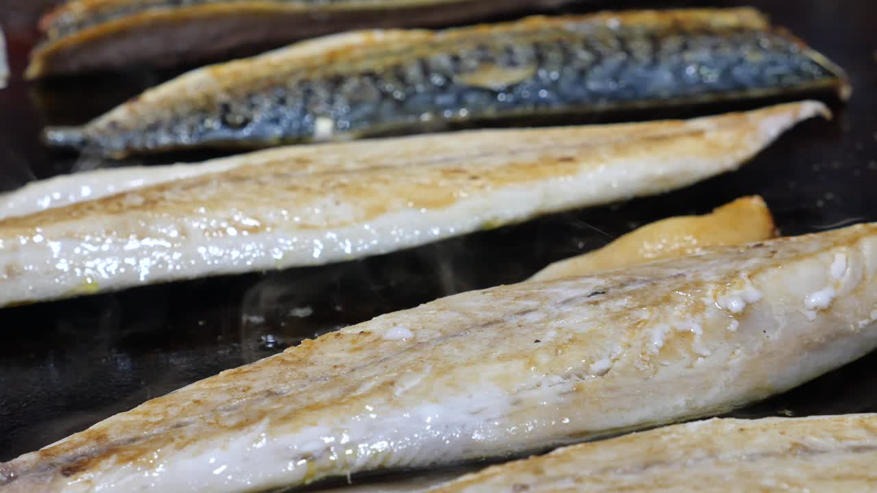 Sizzling Fish Fillets Cooking on a Hot Surface