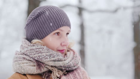 side view of a middle-aged woman in a winter park 4k video