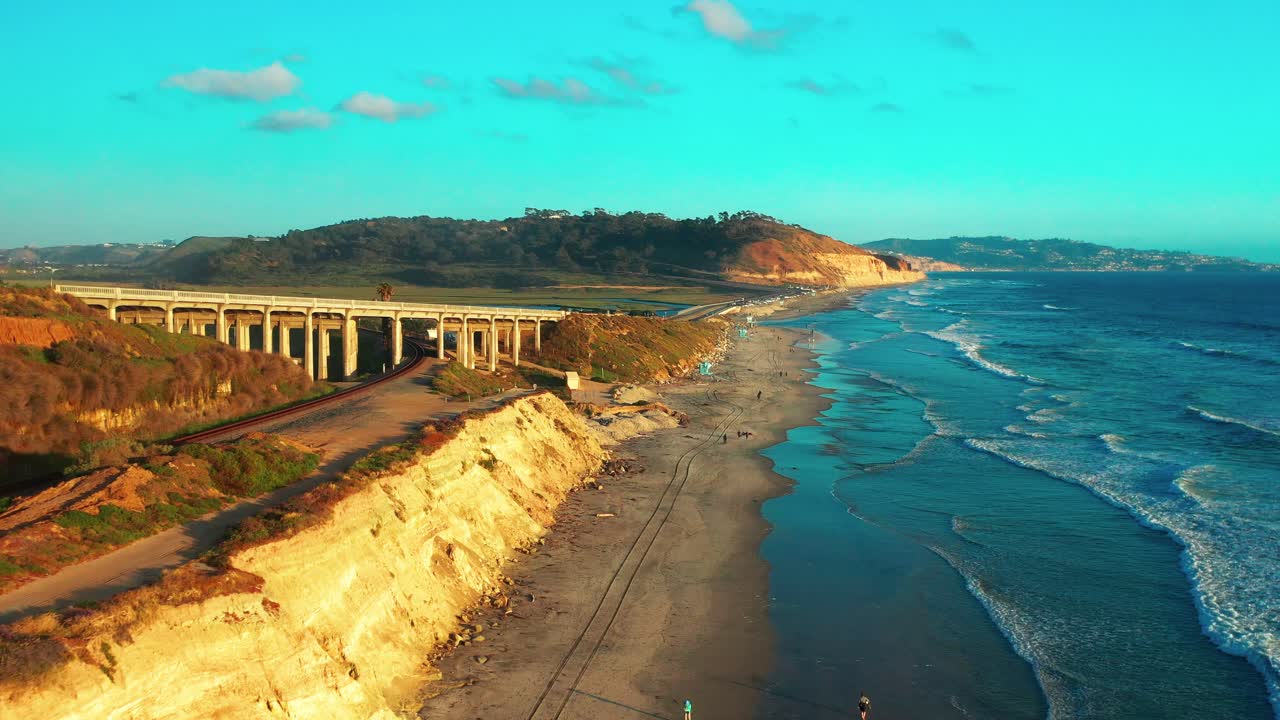 Aerial view of the bluffs and train tracks in Del Mar just before sunset with Torrey Pines and La Jolla in the distance. Tighter of 2
