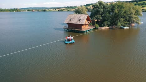 beautiful natural landscape on the island situated on river. aerial shot of a wooden house on island on lake on a sunny day.