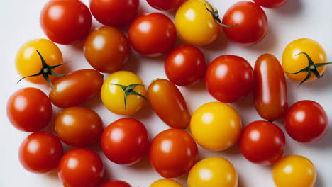 overhead view of scattered red and yellow cherry tomatoes