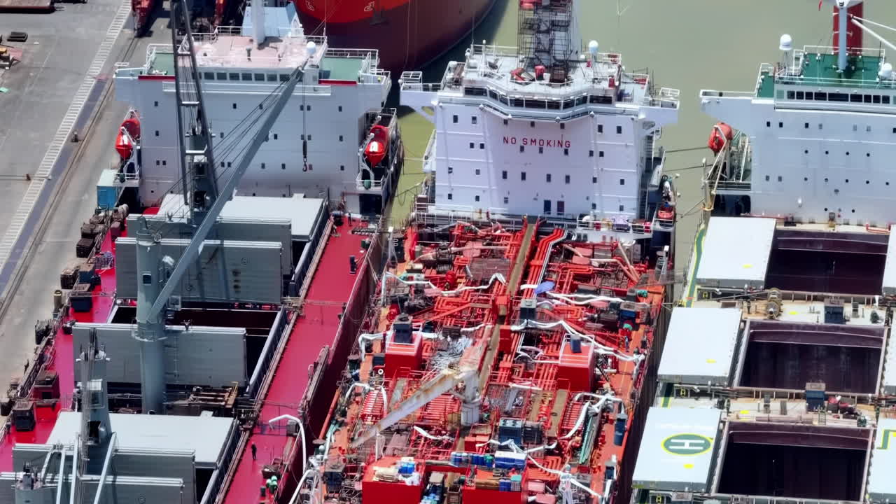 Busy International Logistics Port Cargo Ship transportation with working crane bridge in deep sea port for import export city Automation