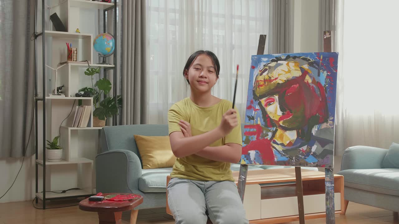 Asian Artist Girl Holding Paintbrush Wipe The Sweat Before Crossing His Arms And Smiling After Finish Painting On The Canvas