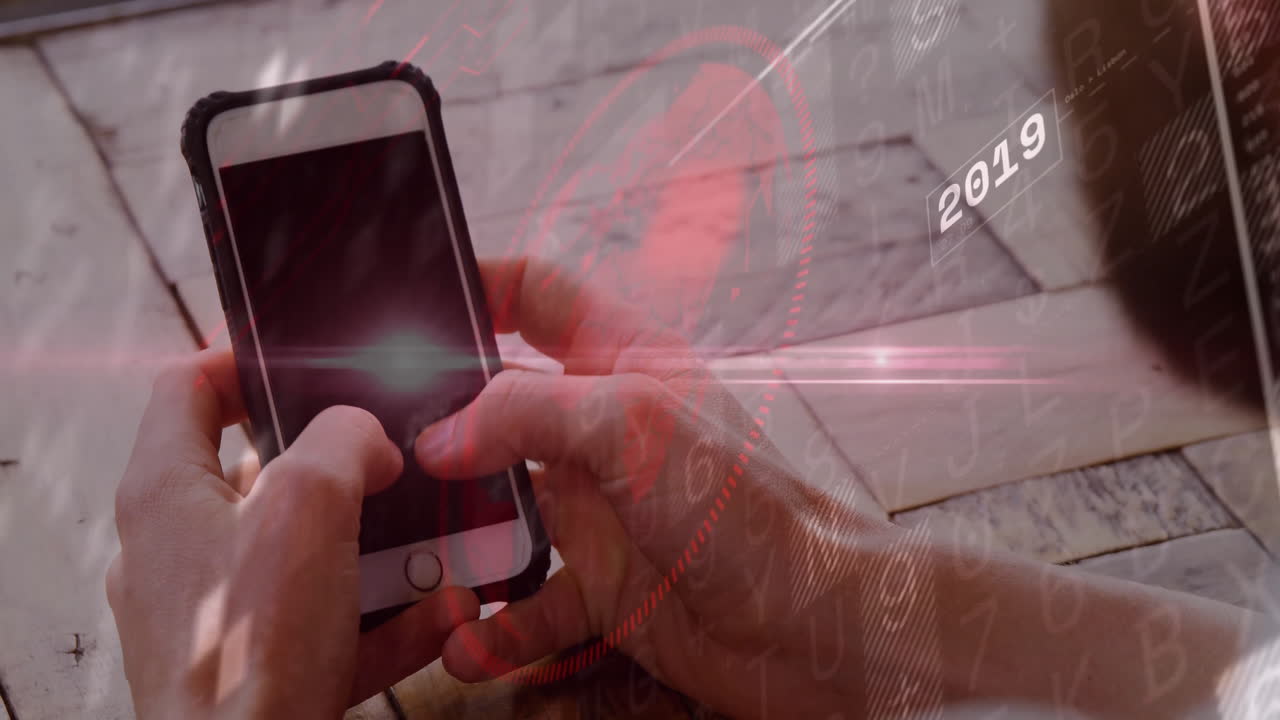 Man's hands holding smartphone over wooden table, displaying tech data with codes 2016, graph