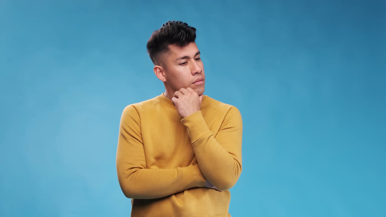 Man thinking about something while standing on an isolated background.