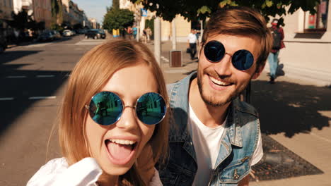 happy couple posing for a selfie in the city