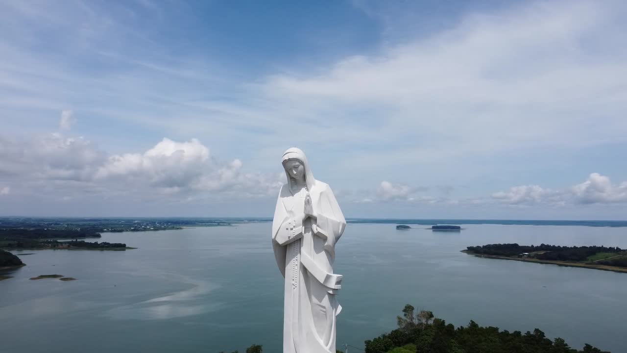 A captivating aerial view of terraced rice fields bathed in soft light under a cloudy sky. Misty mountains tower in the background, creating a serene, timeless atmosphere