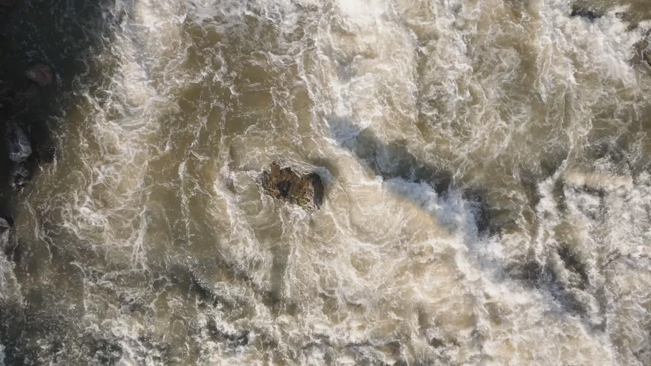 Powerful waterfall rushing over rocks in owen sound, canada, aerial view