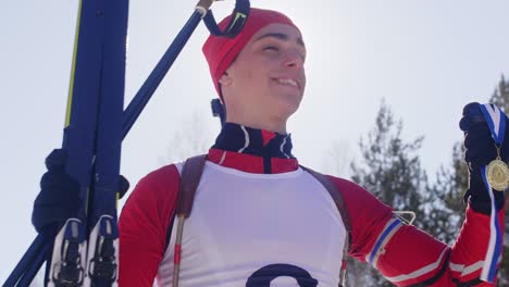 happy winner of biathlon race with gold medal