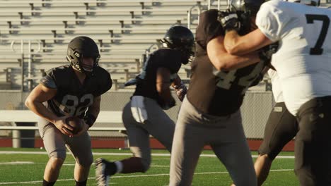 a football player jumps over an opponent and makes a touchdown, in slow motion