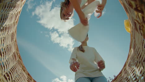 girls sorting clothes in a basket outdoors