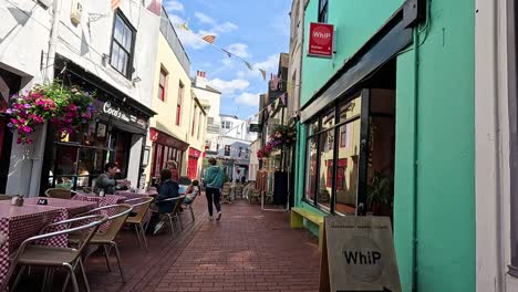 people walking past shops and cafes in brighton