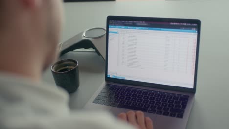 Man-working-and-looking-at-the-laptop-display