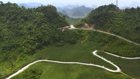4k drone footage of winding road through vietnam's dong karst plateau geopark