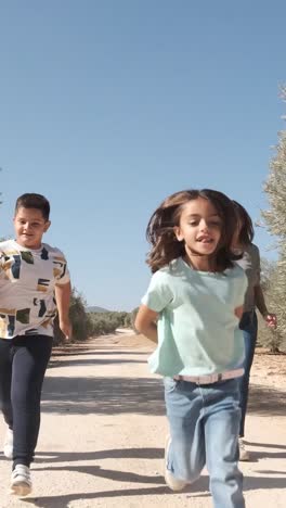 happy family playing while running on a rural path