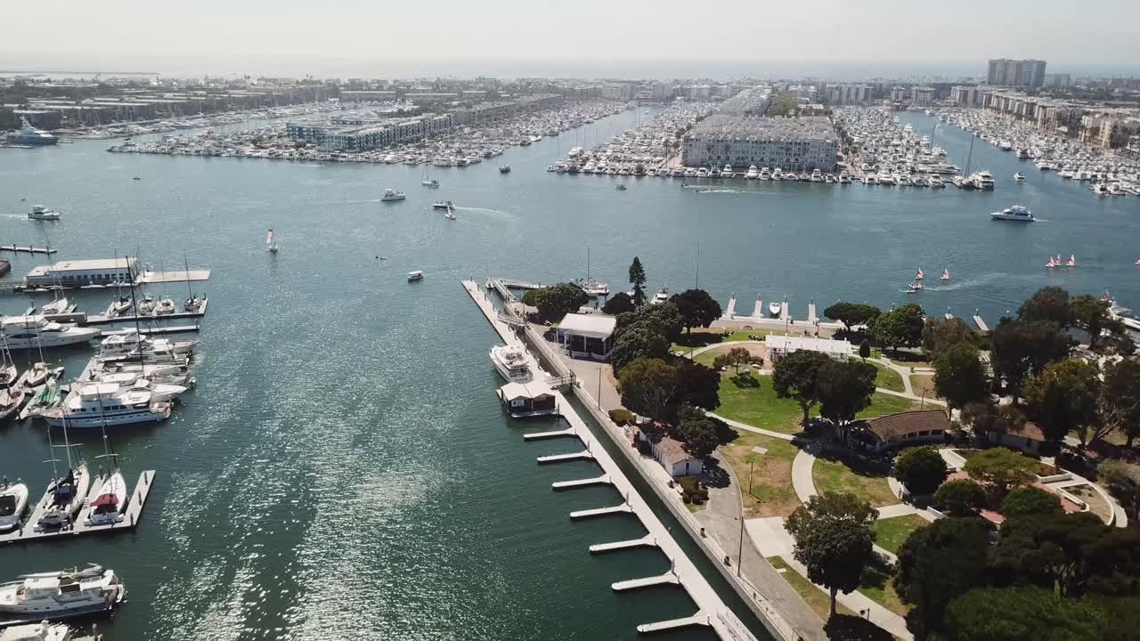 Aerial wide shot of luxury marina del Rey with noble Apartment homes between luxury parking yachts. Sunny summer day in California,usa