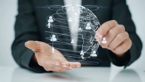 businessman holding a hologram of a global network with people icons