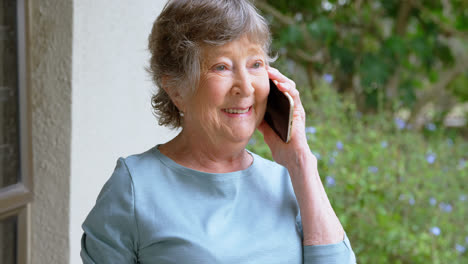 Senior-woman-talking-on-mobile-phone-at-home-4k