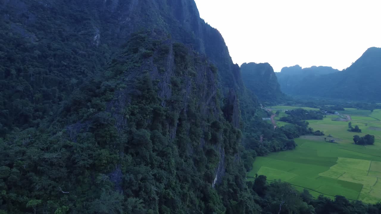 Circle around Limestone Peak reveal Rice paddy and Laos Countryside, drone