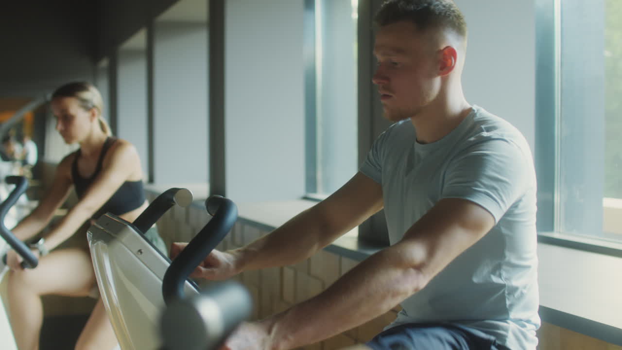 Man Cycling in Gym