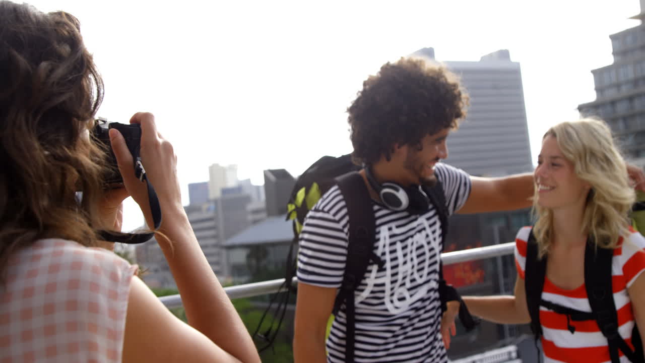 Hipster girl taking her friends in picture