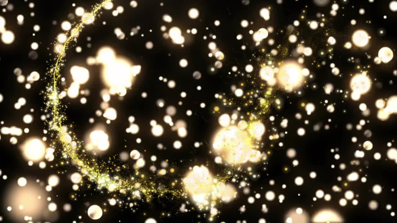 Glowing particles and light trails moving over dark background