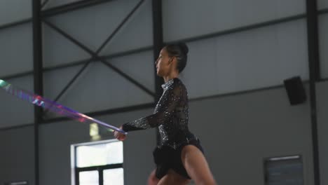 Female-gymnast-performing-at-sports-hall