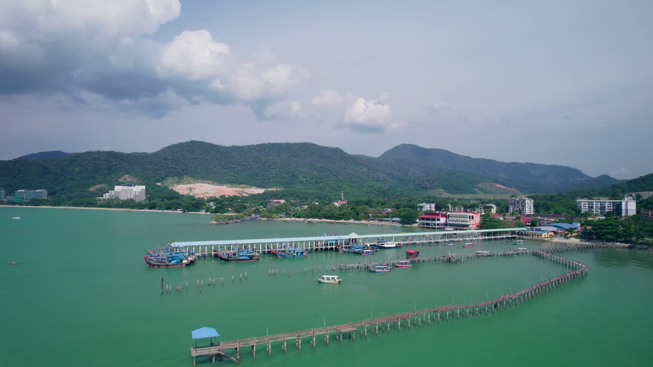 Aerial view showcasing a traditional Malaysian jetty in Teluk Bahang with fishing boats