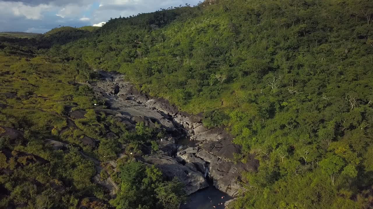 Aerial drone shot flying forward, capturing the expansive natural beauty and unique rock formations of Vale da Lua in Chapada dos Veadeiros, Brazil