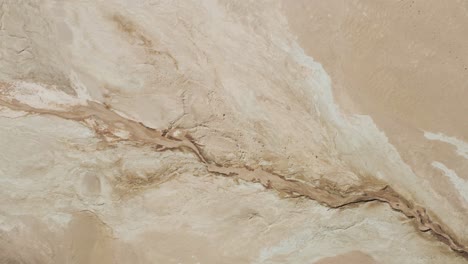 aerial above dry river in arid landscape of iceland, hverarönd