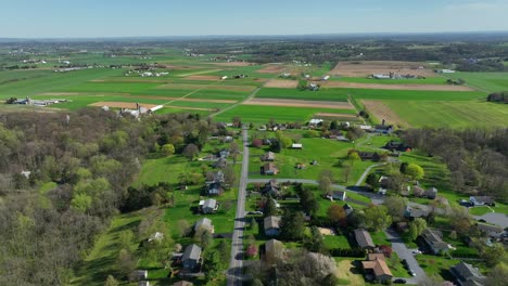 beautiful american suburb homes near forest and rural farm field in pennsylvania