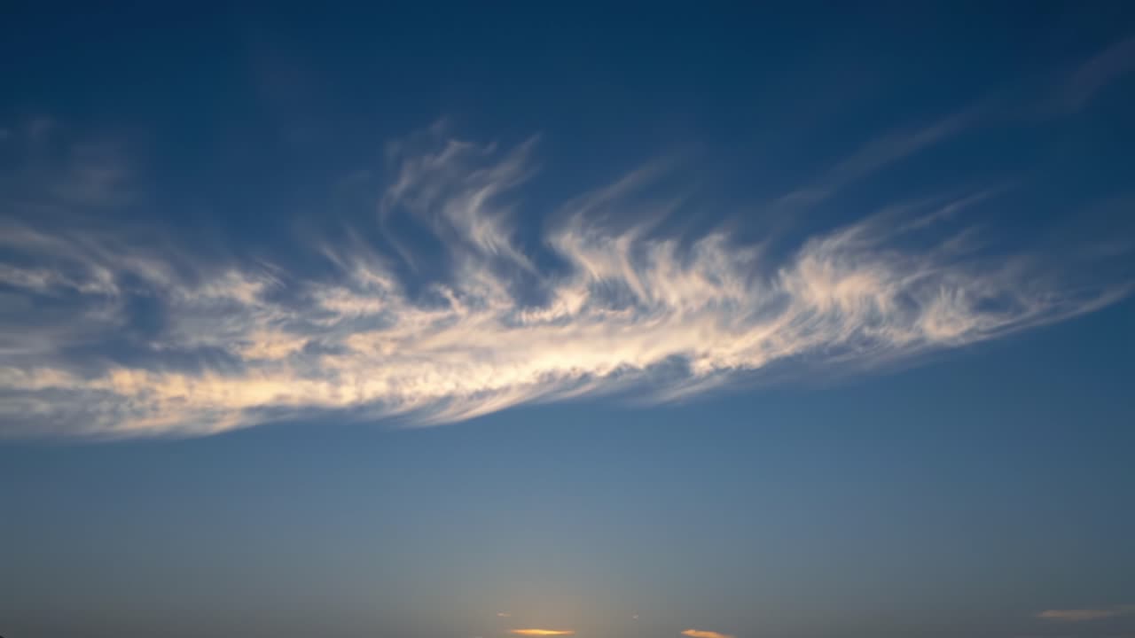 A Majestic Display of Ethereal Clouds in the Twilight Sky: Transitioning from Day to Night Captured in Two Frames