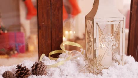 pine cone and lantern decoration on fake snow