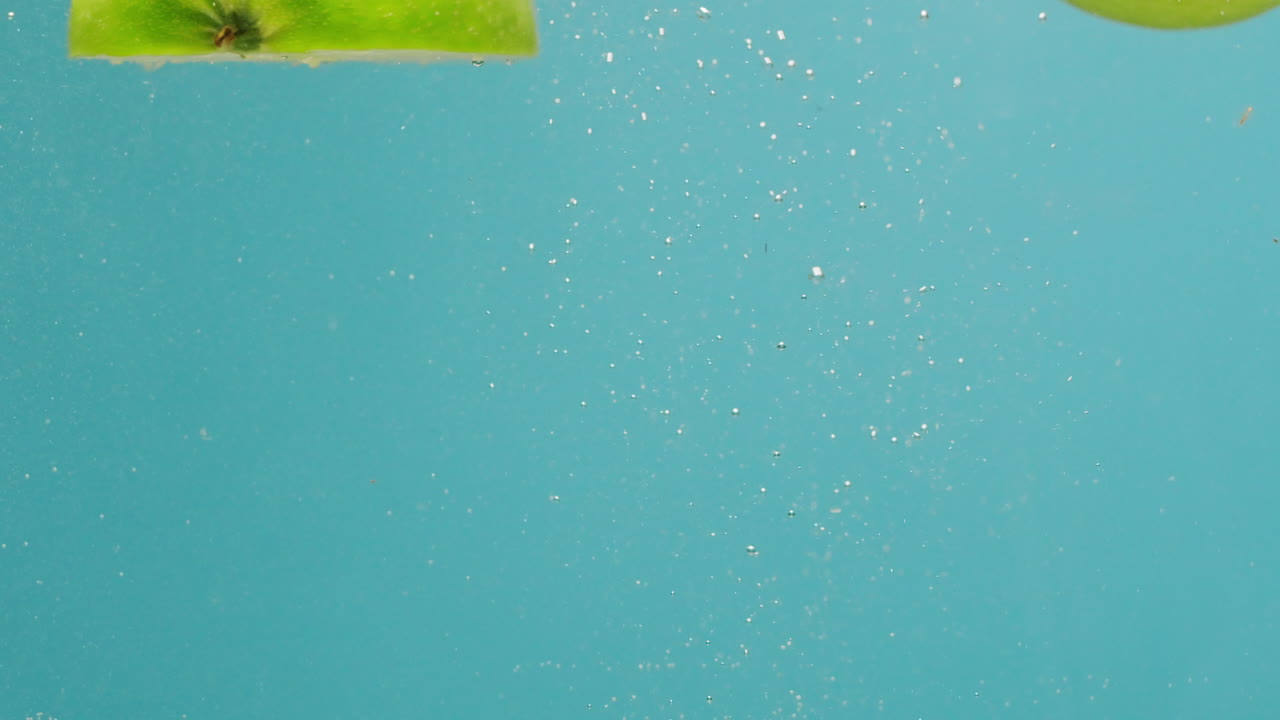 Green Apples Splashing Underwater