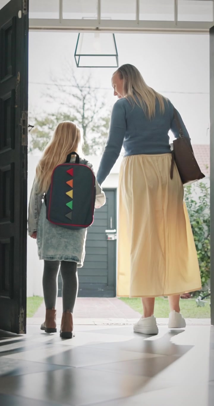 Mother and Daughter Walking Out of Front Door Together