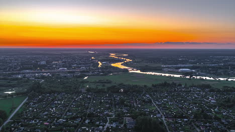 drone hyperlapse sunset over jelgava, latvia with winding lielupe river