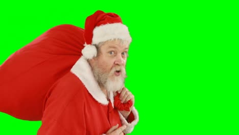 Santa-claus-with-finger-on-lips-carrying-sack