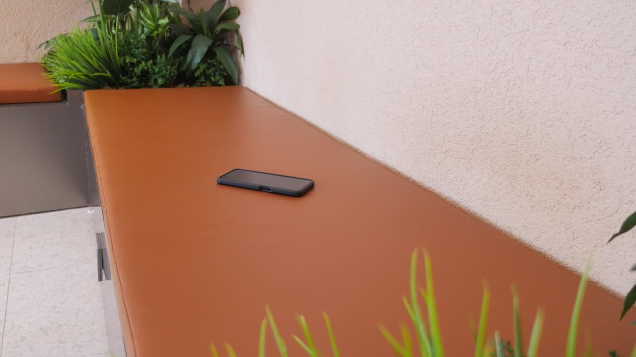 Phone on a Bench in a Waiting Area