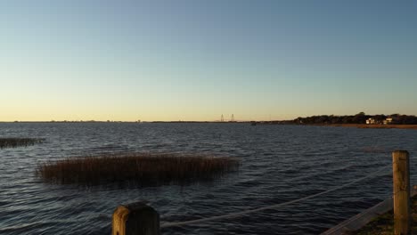 Charleston-harbor-at-sunset,-seen-from-Pitt-Street-Bridge,-Mount-Plesant,-SC