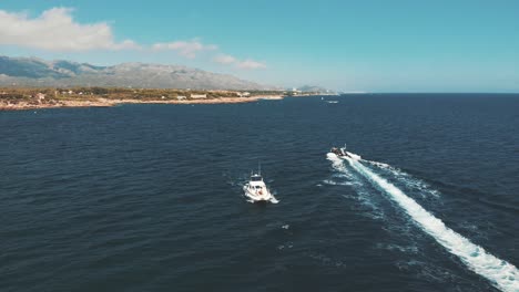 Front-aerial-view-of-a-yacht-sailing-through-the-sea