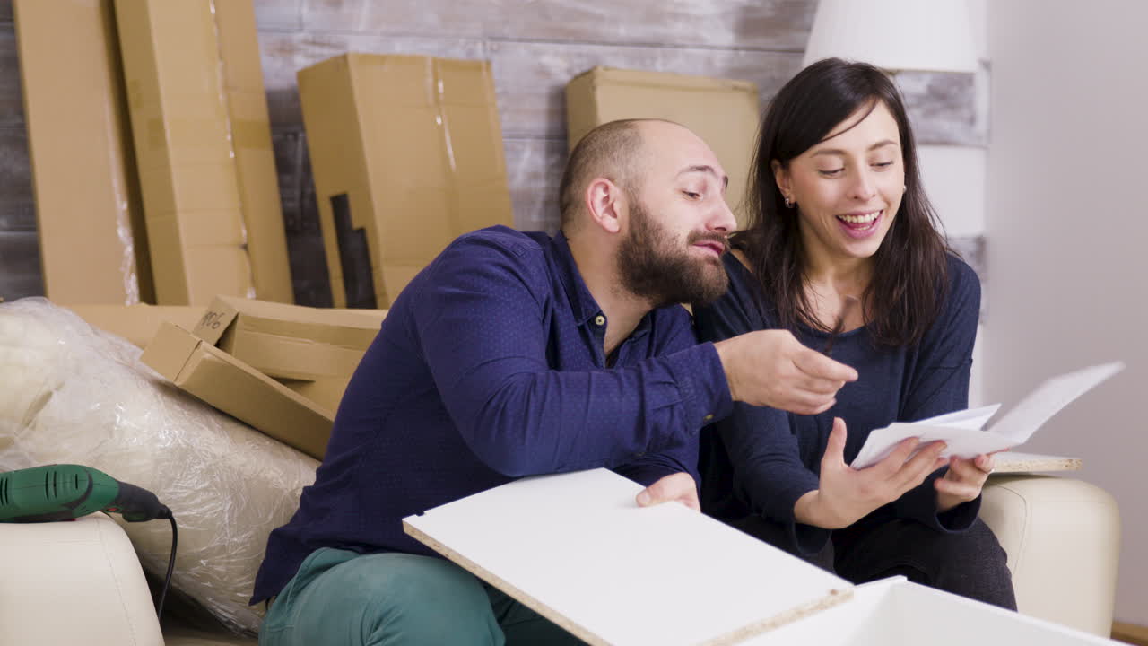 Couple Assembling Furniture in Their New Home