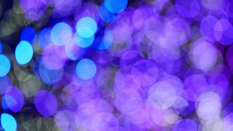 slow pan up and around through colorful bokeh bubbles at night