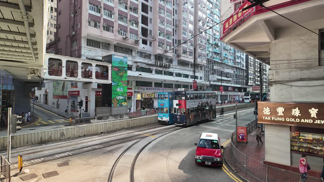 Timelapse View Of Trams and Traffic on King's Road, North Point, Hong Kong on a Sunny Day